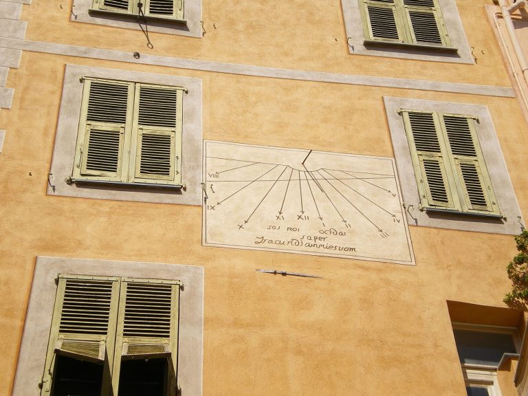 A sundial on a stone wall in Roquebrun in the South of France
