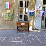 Hopscotch marked on the shaded pavement outside a gift shop in the old city of Carcassonne