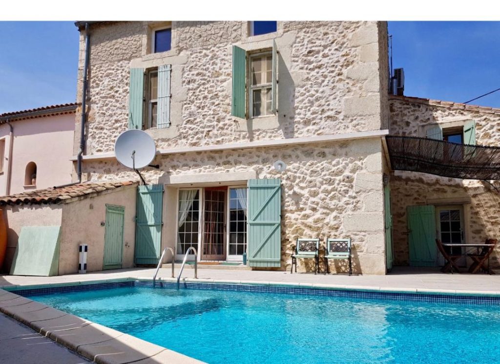 The pool and a renovated traditional stone Mediterranean holiday home in a quiet village