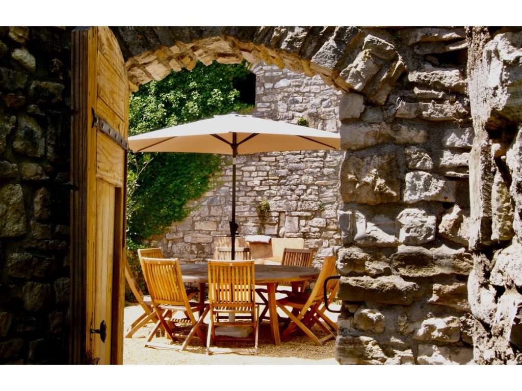 A table and chairs on the terrace of a stunning Mediterranean holiday home in a quiet village location 